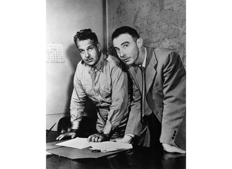 General Groves and Robert Oppenheimer looking at maps of Japan in the weeks before the deployment of the atomic bombs (from the archives of the Department of Energy).jpg